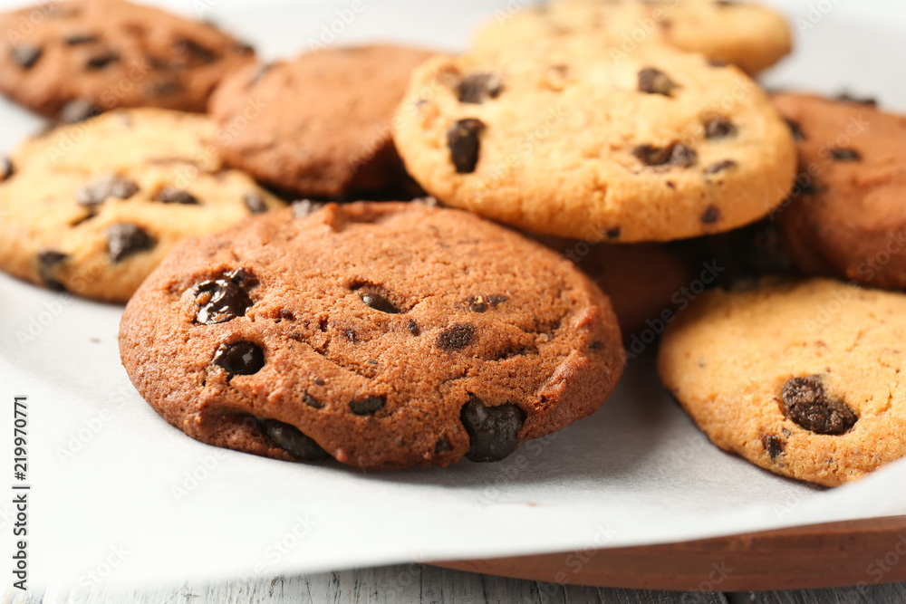 Plate with tasty chocolate cookies on table, closeup Plate with tasty chocolate cookies on table, closeup