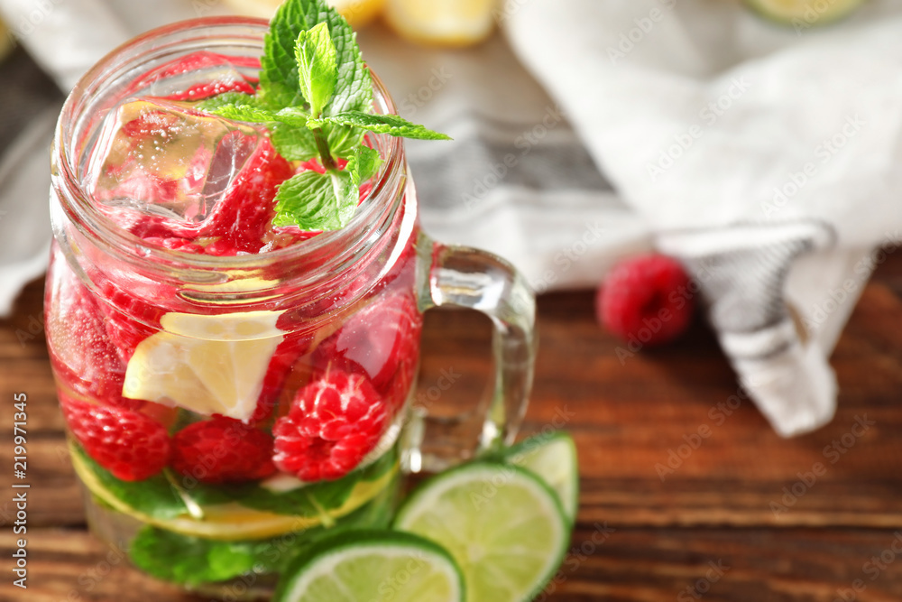 Mason jar of fresh raspberry mojito on wooden table, closeup Mason jar of fresh raspberry mojito on wooden table, closeup