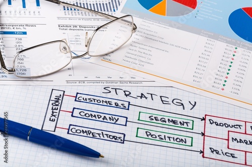 Pen and Eyeglasses on Business Graphs and Business Plan