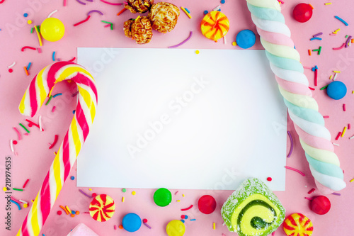 Frame for the text on the background of different, sugar, children's sweets. Candies on a pink background. Copy space, sweets concept