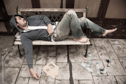 Wallpaper Mural Poor homeless man sleeping on the wooden bench with his cardboard house on the street Torontodigital.ca