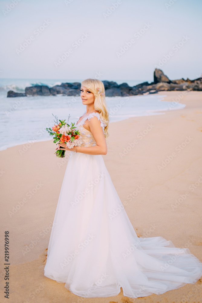 young bride is standing on tropical beach young bride is standing on tropical beach