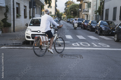 Woman riding bicycle through streets on urban