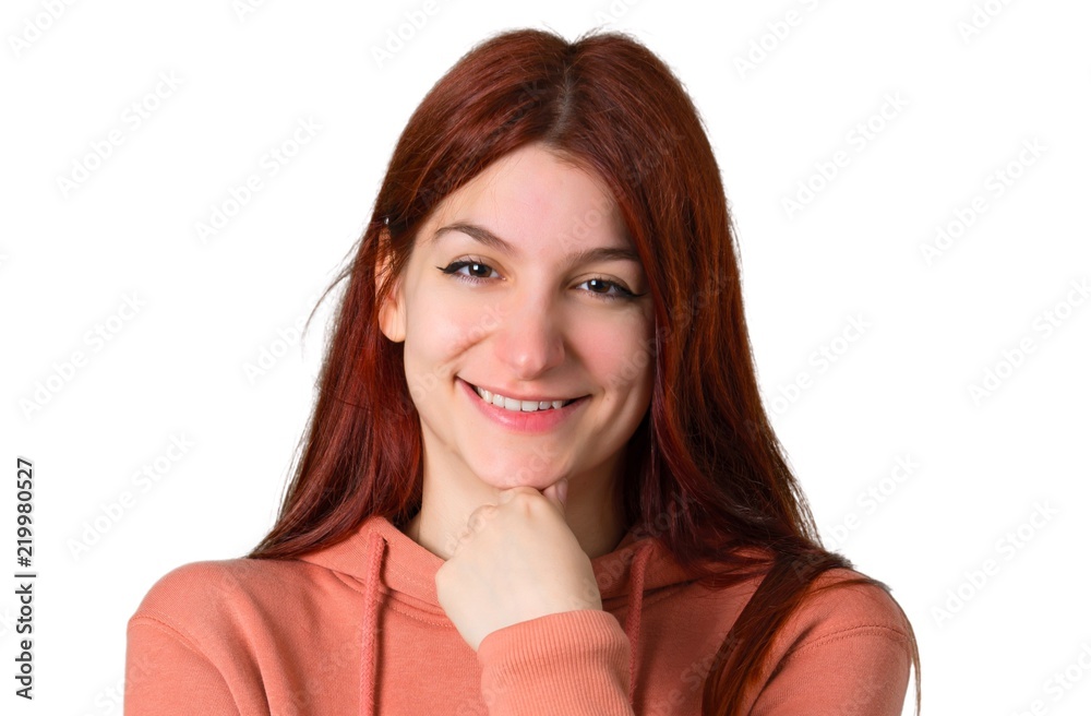 Young redhead girl with pink sweatshirt smiling and looking to the front with confident face on isolated white background Young redhead girl with pink sweatshirt smiling and looking to the front with confident face on isolated white background