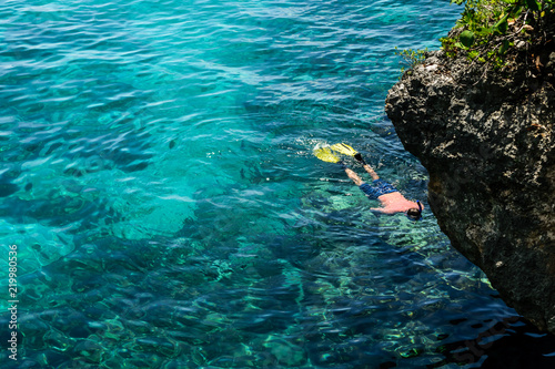Caucasian adult male snorkeling by the cliffs in Negril  Jamaica