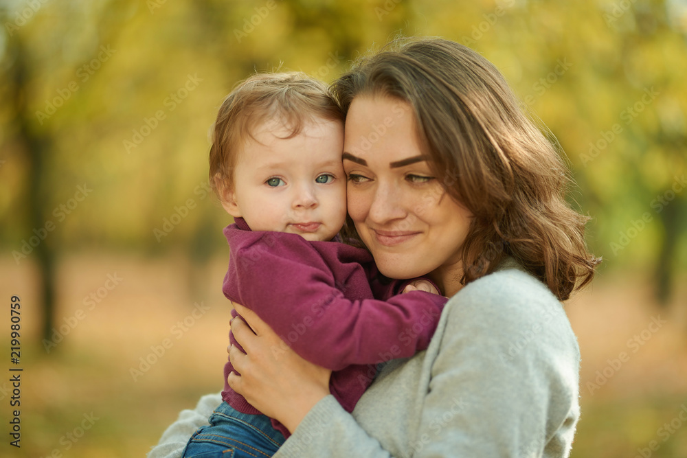 Mom and daughter in an autumn park