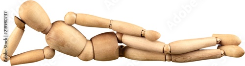Fotografía Miniature wooden mannequin in a laying down pose