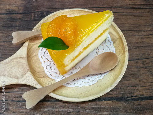 Orange cake on a Wood plate set.