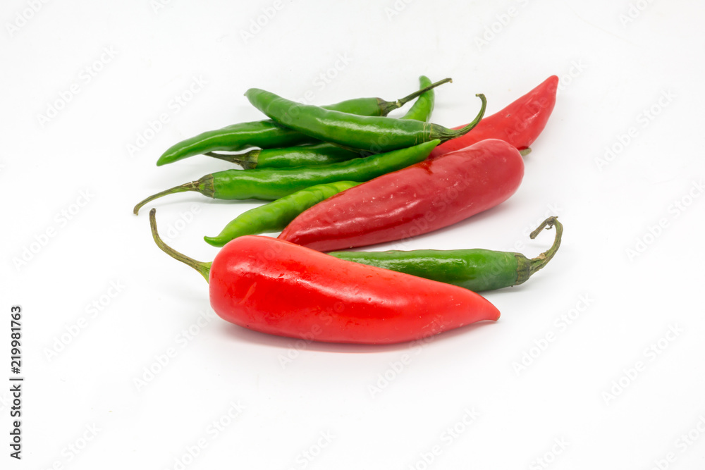 Vibrant red and green chillies isolated against a white background Vibrant red and green chillies isolated against a white background