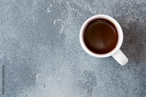 Cup of strong black coffee on a concrete background. Copy space