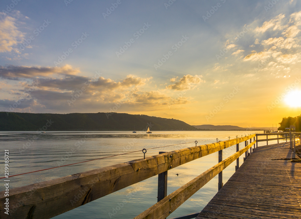 Germany, Landing stage at silent water of lake constance summer sunset