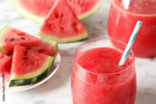 Tasty summer watermelon drink in glass on table, closeup