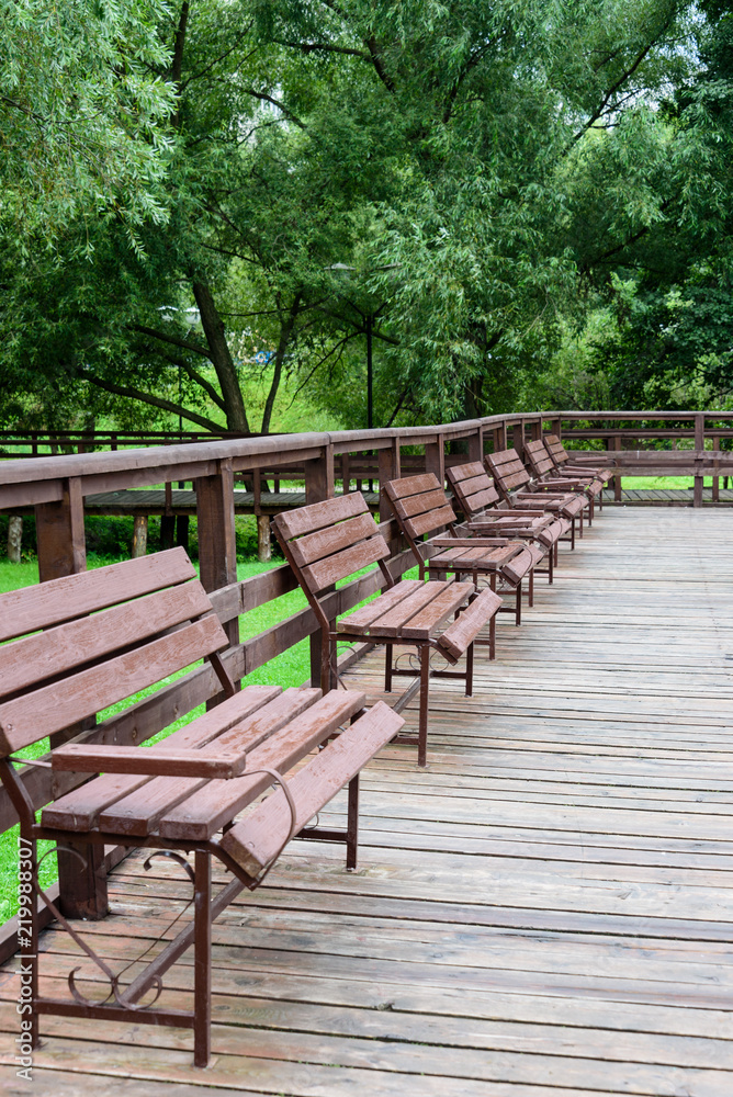 Row of wooden benches in the park Row of wooden benches in the park