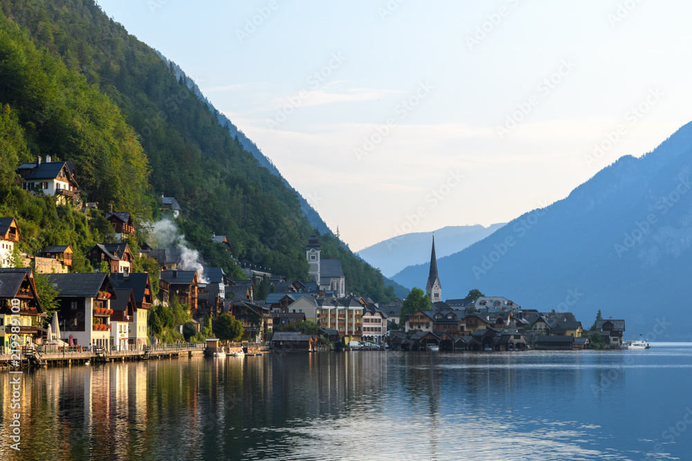 View of the Alpine town of Hallstatt on the shore of a mountain lake at dawn