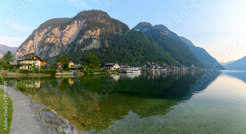 Panoramic views of the Alpine lake and the town of Hallstatt, surrounded by mountains at dawn