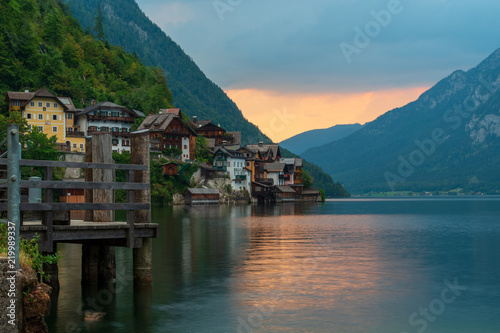 View of the Alpine town of Hallstatt on the shore of a mountain lake at sunset