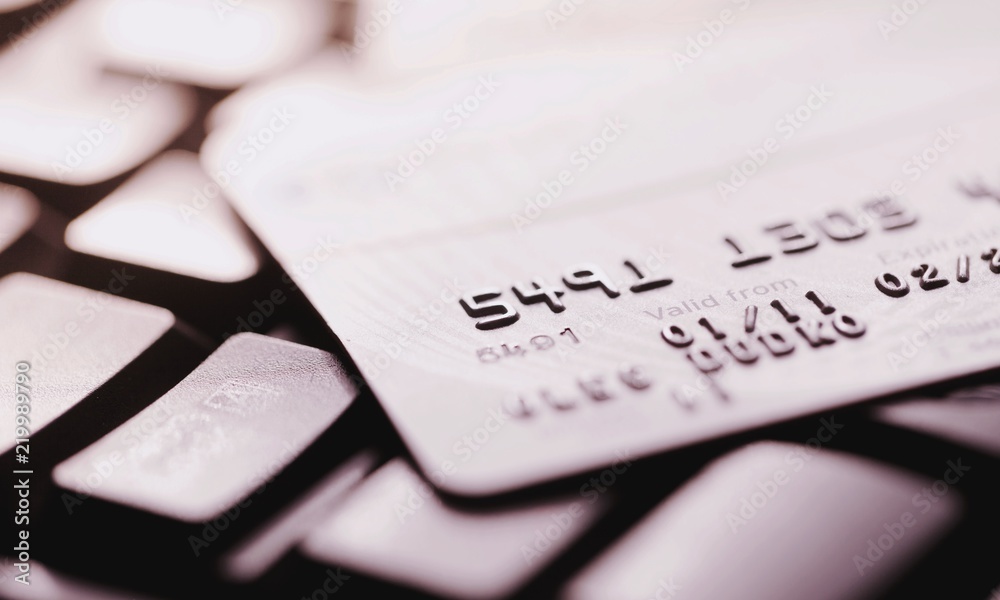 Credit cards stack on laptop background Credit cards stack on laptop background