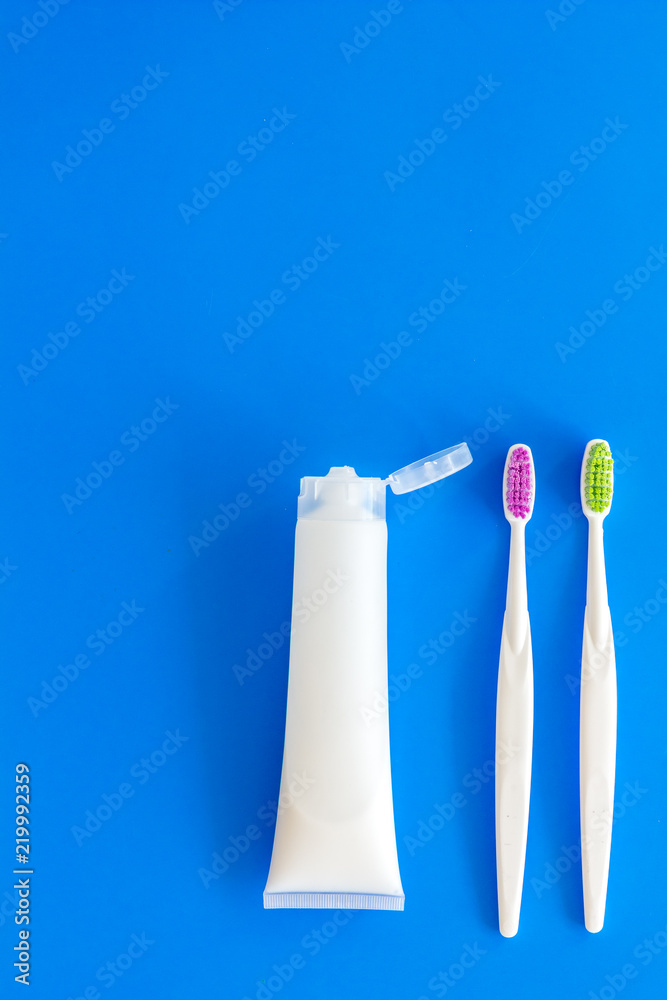 Teeth care, dental care. Toothbrushes and tooth paste on blue background top view space for text Teeth care, dental care. Toothbrushes and tooth paste on blue background top view space for text