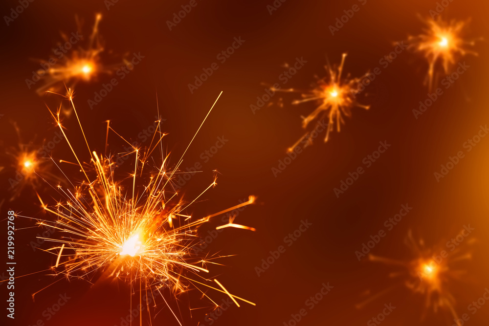 burning sparklers on festive background