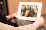 Elderly woman holding a picture frame and watching picture