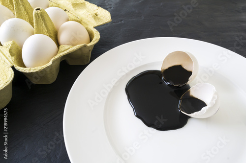 A spoiled egg on a white plate.