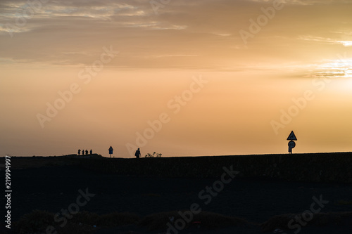 Fototapeta Naklejka Na Ścianę i Meble -  'Mirador del Rio' sunset with a woman,Lanzarote, Spain