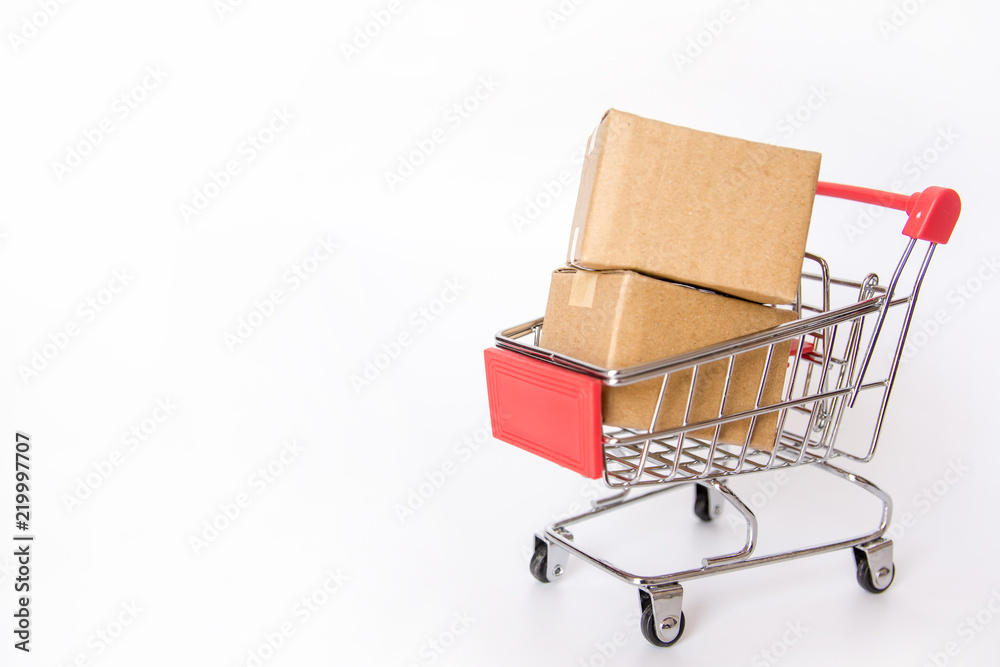 Shopping concept : Cartons or Paper boxes in red shopping cart on white background. online shopping consumers can shop from home and delivery service. with copy space