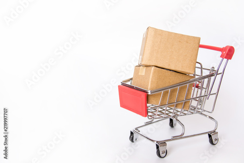 Shopping concept : Cartons or Paper boxes in red shopping cart on white background. online shopping consumers can shop from home and delivery service. with copy space