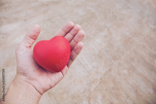 Red heart ball   Stress reliever foam ball the red heart shape on woman hand. Gift valentine s Day