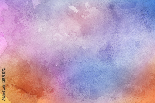 Colorful watercolor ombre leaks and splashes texture on white watercolor paper background. Natural organic shapes and design.