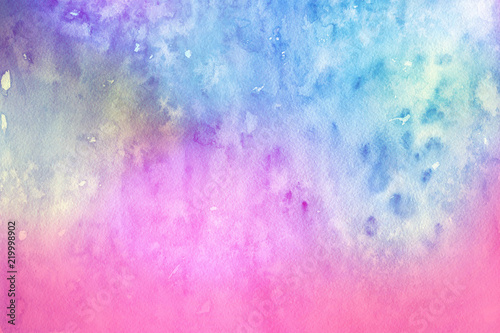 Colorful watercolor ombre leaks and splashes texture on white watercolor paper background. Natural organic shapes and design.