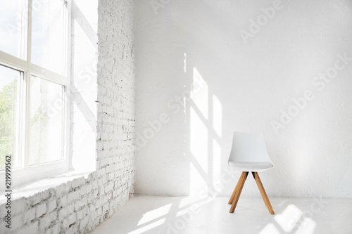 Fototapeta Naklejka Na Ścianę i Meble -  Light minimalism modern scandinavian loft studio interior with cafe furniture chair against white wall near window. Mock up shadows afternoon pattern copy space background.