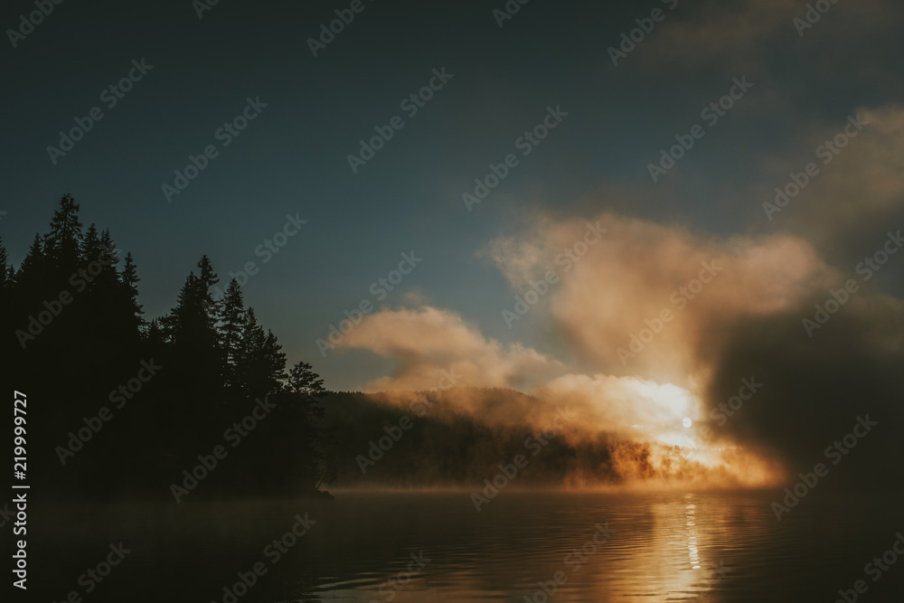 Sunrise on foggy lake