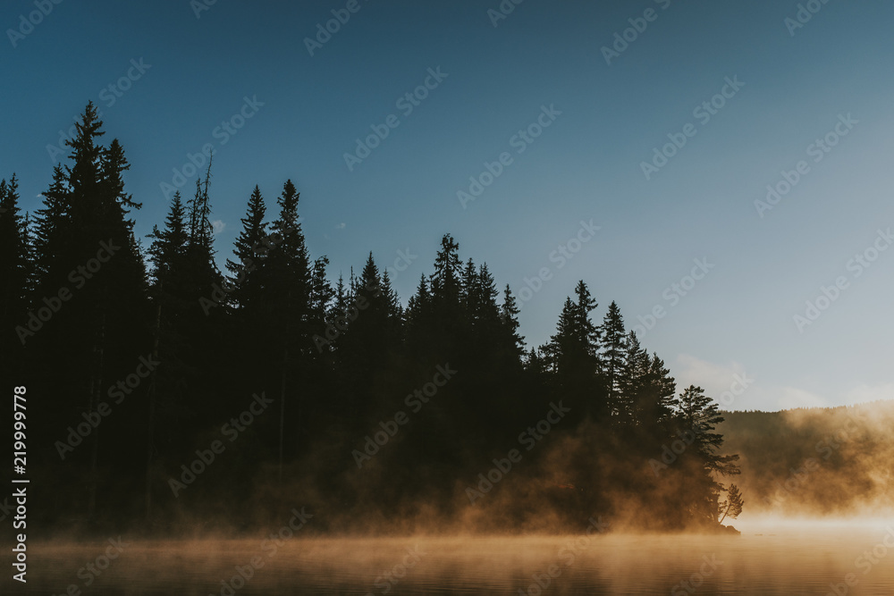 Sunrise on foggy lake