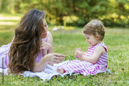 Happy Mother with her Baby Girl in the Summer Park .Mother and Daughter .Happy Family, Mother with Little Child