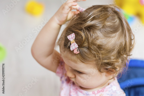 Cute Blondie Baby Girl with Pink Ribbon Hair Clip on her Hair