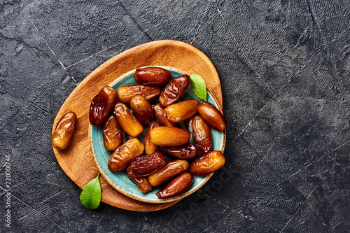 Dried dates fruits on plate with copy space. Top view of pitted dates.