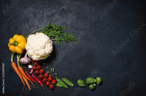 Fresh vegetables on a black background with text space