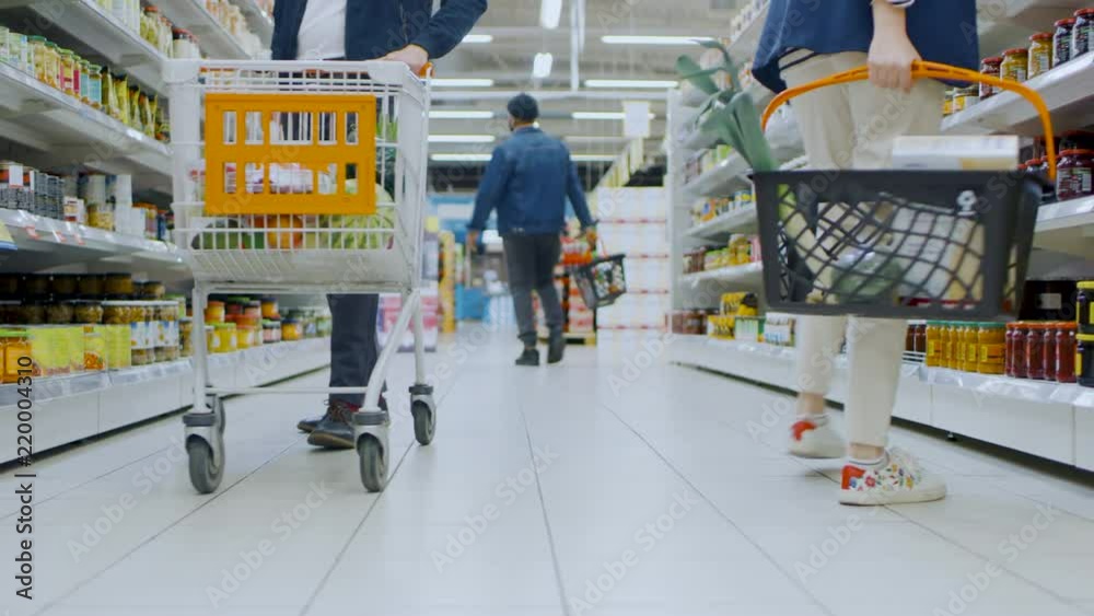 Low Angle Footage At the Supermarket: Canned Goods Section, Customers Browsing Through Shelves and Buying Products.
