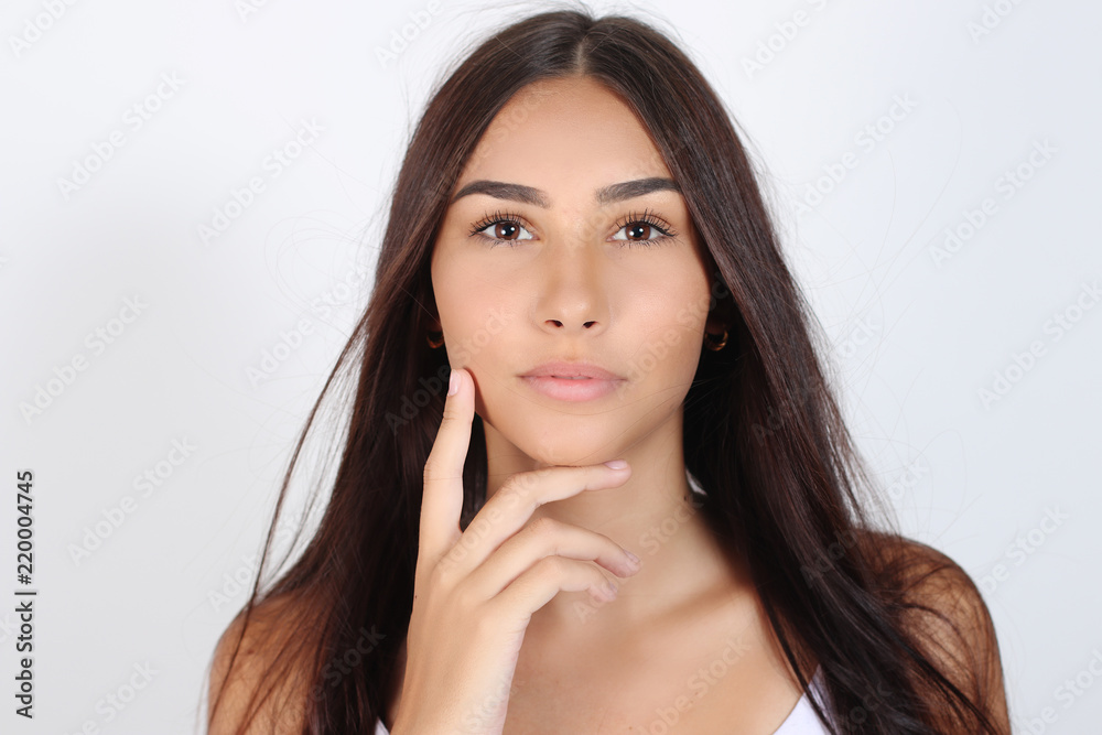 Beautiful face of young adult woman with clean fresh skin, white background, isolated Beautiful face of young adult woman with clean fresh skin, white background, isolated
