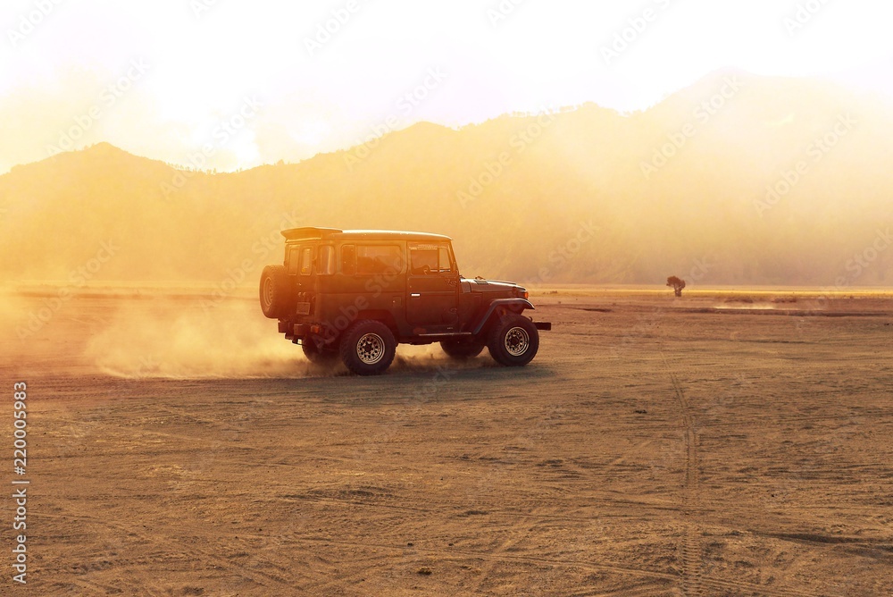 A car is running on the offroad desert in the morning. Outdoor adventure life