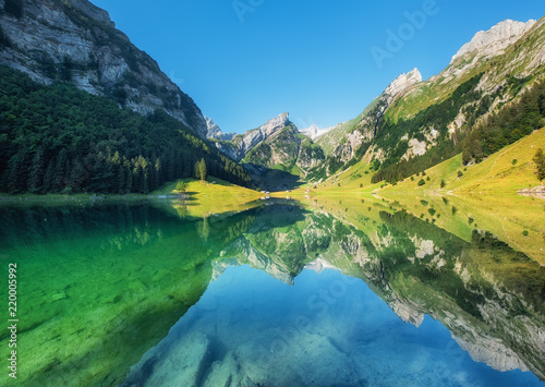 Mountains and lake in the Switzerland. Reflection on the water surface. Natur...