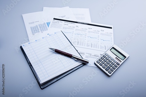 Pen, Balance Book And Calculator On Financial Reports