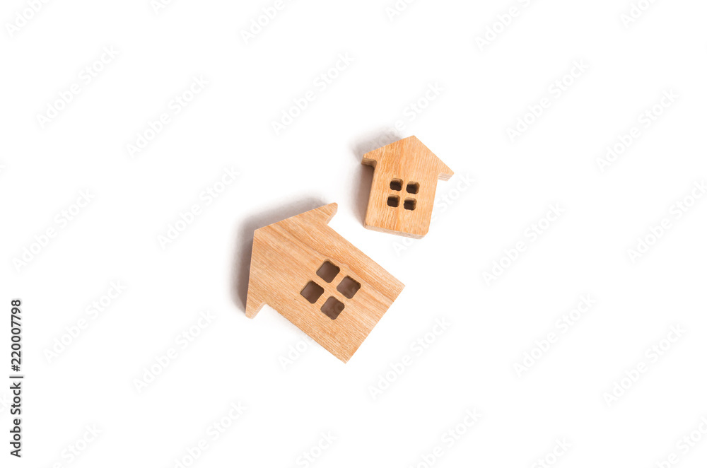 Two wooden houses on a white background. Concept of real estate, buying and selling. Rent. Statistical data. Minimalism. Investments, insurance and construction of housing and business. Two wooden houses on a white background. Concept of real estate, buying and selling. Rent. Statistical data. Minimalism. Investments, insurance and construction of housing and business.