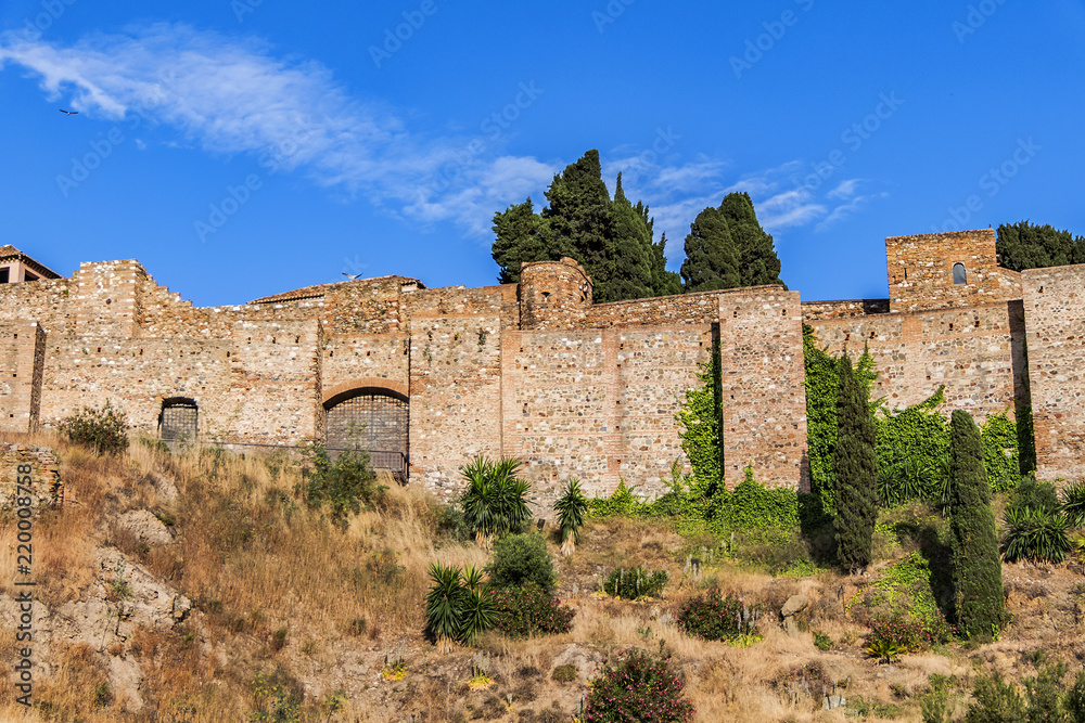 External view of Alcazaba Walls - palatial fortress in Malaga built in XI century. Fortress palace, whose name in Arabic means citadel, is one of city's historical monuments. Malaga, Andalusia, Spain.