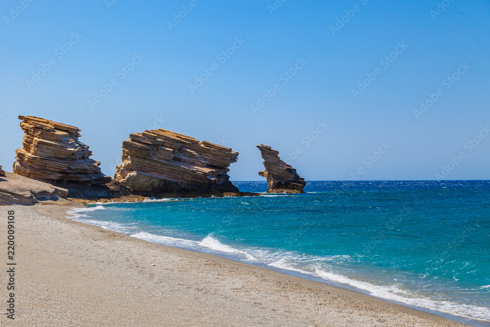 The beach of Triopetra with rocks and turquoise sea in Southern Crete, Greece. Beautiful background Mediterranean sea. The beach of Triopetra with rocks and turquoise sea in Southern Crete, Greece. Beautiful background Mediterranean sea.