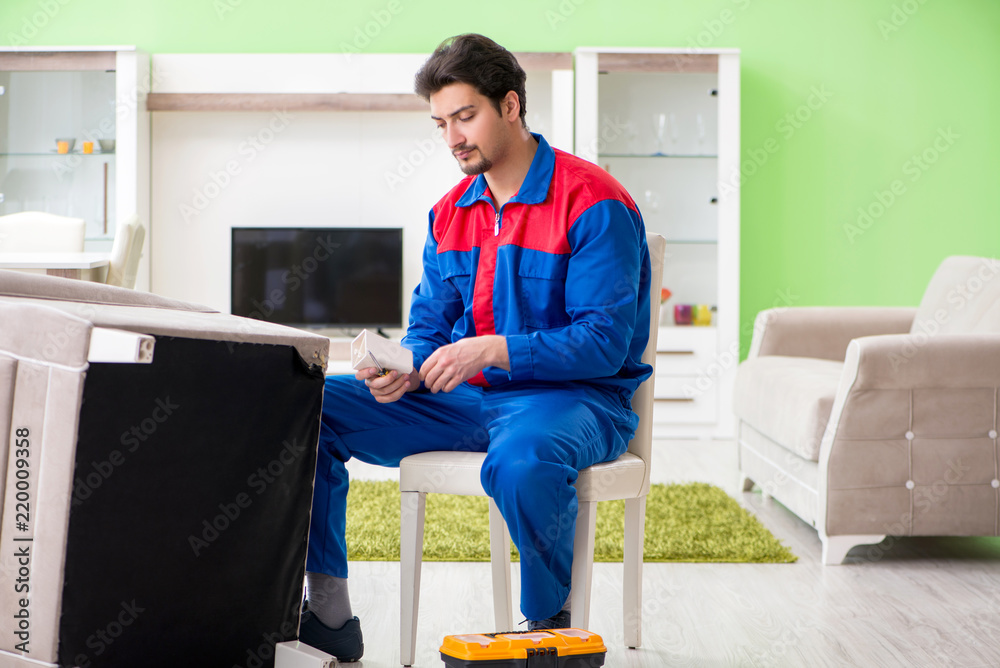 Obraz premium Repair contractor repairing broken furniture at home