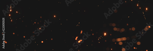 Obraz na płótnie blurred sparks from fire in front of black backgound