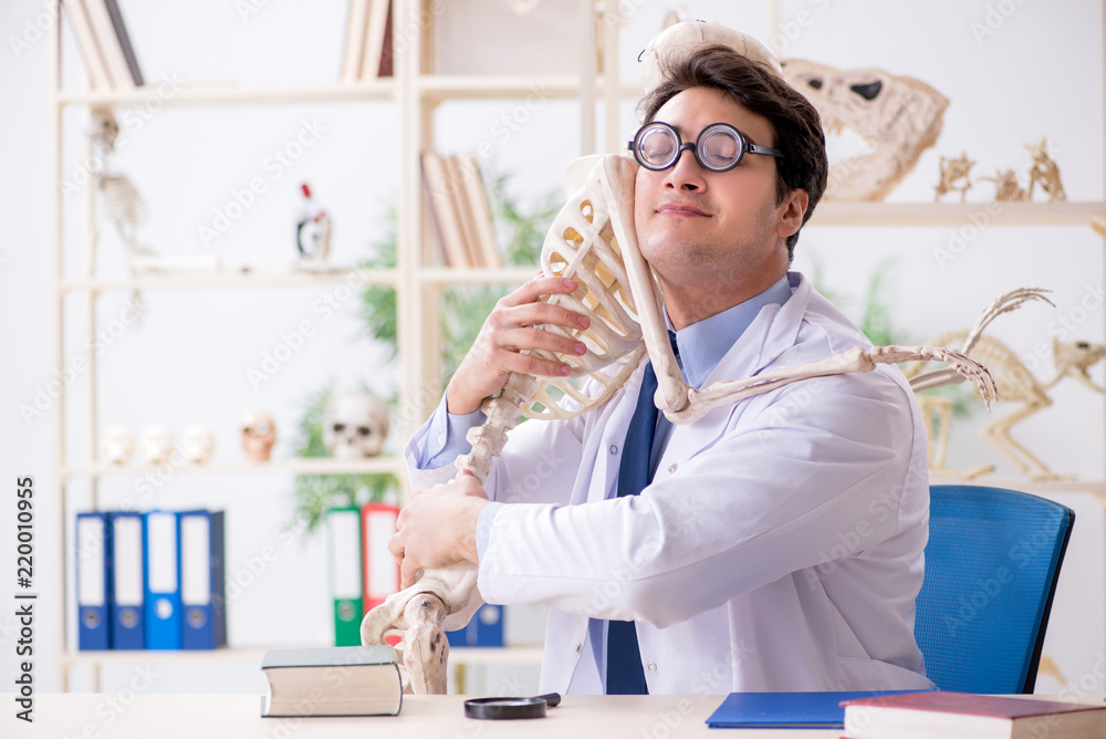 Crazy professor studying human skeleton Crazy professor studying human skeleton