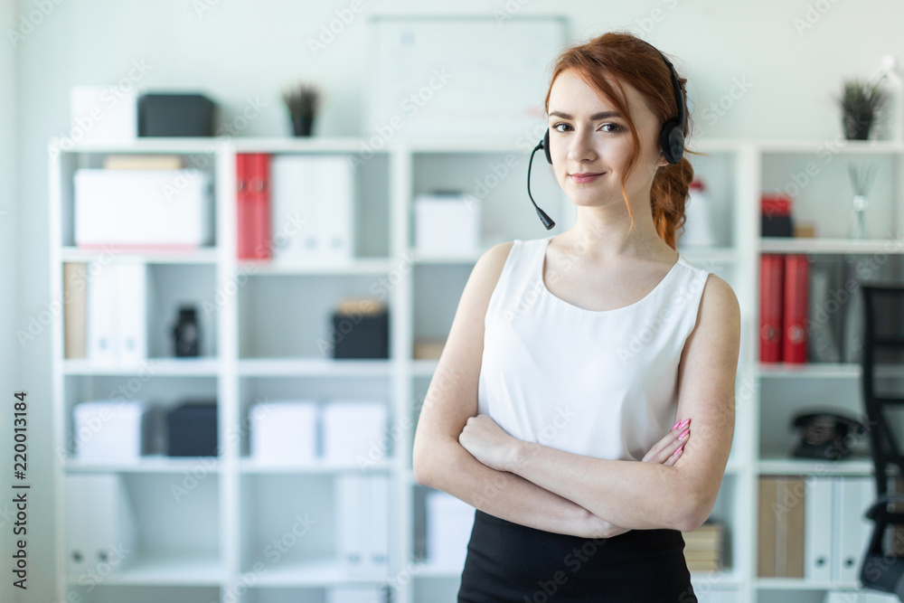 Beautiful young girl in headphones with microphone standing in office. Beautiful young girl in headphones with microphone standing in office.